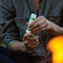 Load image into Gallery viewer, natural organic bug repellent stick outdoors
